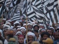 Activists of Islamic political party Jamiat Ulema-e-Islam (JUI) wave party flags during an anti-government "Azadi (Freedom) March" in Islamabad on November 2, 2019. Tens of thousands of Islamists rallied alongside opposition supporters in Pakistan's capital Friday, as the firebrand cleric leading the protests called on Prime Minister Imran Khan's government to step down within 48 hours. FAROOQ NAEEM / AFP