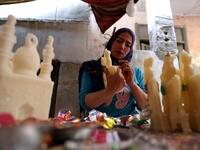 An Egyptian woman decorates traditional sugar statuettes in the capital Cairo on November 2, 2019, ahead of celebrations of the Muslim Prophet Mohammed's birthday, known as "Al Mawlid Al Nabawi". Prophet Mohamed was born in Saudi Arabia's arid mountainous city of Mecca, the holiest in Islam, some 1490 years ago. Sunni Muslims in many parts of the world celebrate his birthday on the 12th day of the third month of the Islamic calendar, which will fall this year on November 9th.  Mohamed el-Shahed / AFP