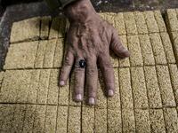 An Egyptian confectioner shows bars of sweets with sesame at a candy factory in the capital Cairo on November 2, 2019, ahead of celebrations of the Muslim Prophet Mohammed's birthday, known as "Al Mawlid Al Nabawi". Prophet Mohamed was born in Saudi Arabia's arid mountainous city of Mecca, the holiest in Islam, some 1490 years ago. Sunni Muslims in many parts of the world celebrate his birthday on the 12th day of the third month of the Islamic calendar, which will fall this year on November 9th.  Mohamed el