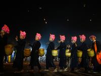 This picture taken on November 4, 2019 shows Pa-O ethnic women performing a traditional dance during the opening ceremony of the Tazaungdaing Lighting Festival at Taunggyi in Myanmar's northeastern Shan State. Brightly coloured balloons with hundreds of homemade fireworks woven into their frames are sent soaring into the night sky, showering down cascades of sparks onto adoring crowds in the annual Taunggyi fire balloon festival. Ye Aung THU / AFP