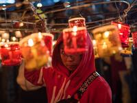 This picture taken on November 4, 2019 shows a participant preparing to release a hot-air balloon during the Tazaungdaing Lighting Festival at Taunggyi in Myanmar's northeastern Shan State. Brightly coloured balloons with hundreds of homemade fireworks woven into their frames are sent soaring into the night sky, showering down cascades of sparks onto adoring crowds in the annual Taunggyi fire balloon festival. SAI AUNG MAIN / AFP