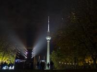 People look at a light show projected onto the Humboldt Forum building as part of the festival week to celebrate the 30th anniversary of the November 9,1989 fall of the Berlin Wall, in Berlin on November 5, 2019. Germany marks three decades since the fall of the Berlin Wall this week with main celebrations on November 9, 2019. John MACDOUGALL / AFP