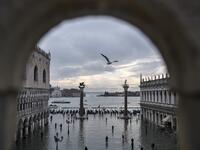 A general view shows the Doge's Palace (L) overlooking the flooded St. Mark's Square, the Lion of St. Mark winged bronze statue (Rear L), gondolas and the Venetian lagoon in the distance after an exceptional overnight "Alta Acqua" high tide water level, on November 13, 2019 in Venice. Venice was hit by the highest tide in more than 50 years late November 12, with tourists wading through flooded streets to seek shelter as a fierce wind whipped up waves in St. Mark's Square. Marco Bertorello / AFP