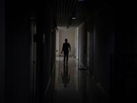 This photo taken on October 23, 2019 shows pet detective Sun Jinrong searching for a missing cat in a residential compound in Beijing. Private sleuth Sun Jinrong brings heat detectors, tiny surveillance cameras, and a blowdart loaded with a tranquiliser to his search for one desperate client's missing loved one: A cat named Duoduo.  NOEL CELIS / AFP