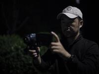 This photo taken on October 23, 2019 shows pet detective Sun Jinrong using a night vision camera as he searches for a missing cat in a residential compound in Beijing. Private sleuth Sun Jinrong brings heat detectors, tiny surveillance cameras, and a blowdart loaded with a tranquiliser to his search for one desperate client's missing loved one: A cat named Duoduo.  NOEL CELIS / AFP