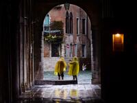 People take pictures in a street near the Rialto Bridge, on November 15, 2019 in Venice, two days after the city suffered its highest tide in 50 years. Flood-hit Venice was bracing for another exceptional high tide on November 15, as Italy declared a state of emergency for the UNESCO city where perilous deluges have caused millions of euros worth of damage. Filippo MONTEFORTE / AFP
