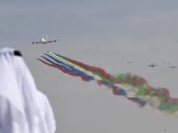 An emirati man watches the United Arab Emirates' air force Aerobatic Team, Al-Fursan, performing along with an Emirates Airline's Airbus A380 at the Dubai Airshow November 17, 2019. KARIM SAHIB / AFP