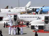 This picture taken on November 18, 2019 shows a general view of visitors walking past aircraft on display during the 2019 Dubai Airshow. KARIM SAHIB / AFP