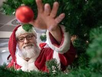 A man dressed as Santa Claus grabs a Christmas ball during an event on November 21, 2019 at the job center in Hanover, northern Germany, where informations were given on how to become a seasonal Christmas helper. Sina Schuldt / DPA / AFP