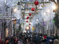 People walk under Christmas decorations during the traditional Christmas market in Strasbourg, eastern France, on November 23, 2019. FREDERICK FLORIN / AFP