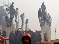 People watch Hindu devotee slaughter buffalos as offering during the Gadhimai Festival in Bariyarpur on December 3, 2019. Thousands of Hindu devotees gathered in southern Nepal for a festival believed to be the world's biggest ritual animal slaughter, despite court orders and calls by animal activists to end the event. The sacrifices take place every five years in Bariyarpur village close to the Indian border, in honour of the Hindu goddess of power. Prakash MATHEMA / AFP