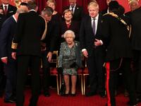 Britain's Queen Elizabeth II (C) sits as leaders come together at Buckingham Palace in central London on December 3, 2019, for a group picture to mark 70 years of the alliance ahead of the NATO alliance summit. NATO leaders gather Tuesday for a summit to mark the alliance's 70th anniversary but with leaders feuding and name-calling over money and strategy, the mood is far from festive. Yui Mok / POOL / AFP