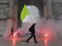A man holds a yellow flag during a demonstration to protest against the pension overhauls, in Marseille, southern France, on December 5, 2019 as part of a national general strike. Trains cancelled, schools closed: France scrambled to make contingency plans on for a huge strike against pension overhauls that poses one of the biggest challenges yet to French President's sweeping reform drive. CLEMENT MAHOUDEAU / AFP