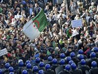 Algerian security surround protesters during an anti-government demonstration in the capital Algiers on December 11, 2019, ahead of the presidential vote scheduled for December 12. Algeria's contentious presidential election campaign is highlighting the vast gap between youth at the heart of a reformist protest movement and an ageing elite they see as clinging to power. RYAD KRAMDI / AFP