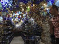 A Palestinian craftsman shapes molten glass into Christmas ornaments at his workshop in the southern West Bank city of Hebron, on December 15, 2019. HAZEM BADER / AFP
