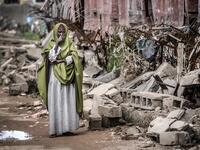 A woman reacts while looking at the destruction left after heavy rains and floods in the school in front of her house in Beledweyne, Somalia, on December 14, 2019. The rains have inundated big areas surrounding Beledweyne area forcing thousands of people to leave their houses and look for humanitarian assistance while living in displacement camps. Due to climate change and human activities, cycles of floods and droughts have become more recurrent and completely unpredictable in Somalia exposing hundreds of 