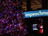 US President Donald Trump is shown on a screen speaking from a rally in Michigan as the the Fox News Headquarters ticker flashes the news of his impeachment for abuse of power in New York on December 18, 2019. US President Donald Trump was impeached for abuse of power in a historic vote in the House of Representatives on December 18, 2019, setting up a Senate trial on removing him from office after three turbulent years. TIMOTHY A. CLARY / AFP