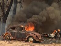 An old car burns from bushfires in Balmoral, 150 kilometres southwest of Sydney on December 19, 2019. A state of emergency was declared in Australia's most populated region on December 19, as a record heat wave fanned unprecedented bushfires. PETER PARKS / AFP