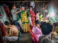 This photograph taken on December 28, 2019 shows actors preparing for a Chinese opera performance by Thailand's Sai Bo Hong troupe on a makeshift stage at a street festival in Bangkok. An ancient world of swords, warriors and folklore roars to life on the darkened street, offering a momentary escape from the modern-day bustle of Bangkok's unstoppable development. For centuries, troupes like the Sai Bo Hong Chinese opera have performed throughout Thailand, where 14 percent of the population are ethnic Chines