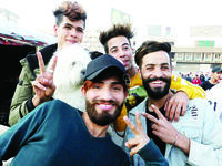 Iraqi anti-government demonstrators sporting a pompadour hairstyle pose at Tahrir Square in central Baghdad on December 23, 2019. Since the start of Iraq's anti-government protests on October 1, one thing strikes the eye perhaps above all else -- the unbridled hairstyles young men sport. High quiffs, tight fades and loads of attitude -- it is quite the male beauty pageant. SABAH ARAR / AFP