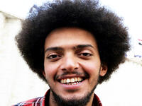 An Iraqi anti-government protestor poses with a distinct hairstyle at Tahrir Square in central Baghdad on December 23, 2019. Since the start of Iraq's anti-government protests on October 1, one thing strikes the eye perhaps above all else -- the unbridled hairstyles young men sport. High quiffs, tight fades and loads of attitude -- it is quite the male beauty pageant. SABAH ARAR / AFP
