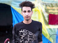 An Iraqi anti-government demonstrator sporting a pompadour hairstyle poses in the southern city of Basra on December 23, 2019. Since the start of Iraq's anti-government protests on October 1, one thing strikes the eye perhaps above all else -- the unbridled hairstyles young men sport. High quiffs, tight fades and loads of attitude -- it is quite the male beauty pageant. Hussein FALEH / AFP