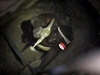 A gold miner works underground in Anka near Gusau, on December 4,2019. For generations, the mineral-rich earth of Nigeria's Zamfara state has provided families living here with a way to make ends meet. But in recent years their trade has become increasingly unsafe. The mines lie within the reach of heavily-armed groups -- dubbed "bandits" by the local authorities -- that have been terrorising this remote region.  Kola Sulaimon / AFP