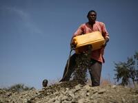 A miner dumps rocks out of a platic container in Anka near Gusau, on December 4,2019. For generations, the mineral-rich earth of Nigeria's Zamfara state has provided families living here with a way to make ends meet. Kola Sulaimon / AFP