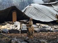 A statue at a burnt house is seen after an overnight bushfire in Quaama in Australia's New South Wales state on January 6, 2020. Reserve troops were deployed to fire-ravaged regions across three Australian states on January 6 after a torrid weekend that turned swathes of land into smouldering, blackened hellscapes. SAEED KHAN / AFP