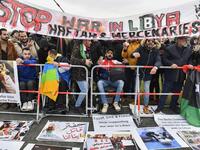 Protesters hold a banner reading "Stop war in Libya, Haftar and mercenaries" during a protest near the chancellery during the Peace summit on Libya at the Chancellery in Berlin on January 19, 2020.  AFP