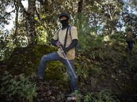 Members of the Regional Coordinator of Community Authorities (CRAC-PF) community police force patrol the village of Ayahualtempan, Guerrero State, Mexico, on January 24, 2020. The CRAC-PF vigilante group trains children as young as five so they can protect themselves from drug-related criminal groups operating in the area. Pedro PARDO / AFP