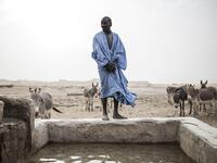 A man is seen at one of the few water wells along the caravan route from Tichitt to Aratane in Mauritania on January 25, 2020. In the arid West African country of Mauritania, the way of life of the traditional group of hunters known as the Nemadi is slowly disappearing. JOHN WESSELS / AFP
