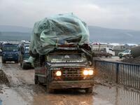 Syrians displaced from the south of Idlib province travelling in vehicles loaded with furniture and other belongings and fleeing from advancing government forces arrive at a camp for the internally displaced near Dayr Ballut, near the Turkish border in the rebel-held part of Aleppo province in the country's northwest on February 4, 2020. Rami al SAYED / AFP