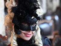 Masked reveller poses St Mark Square during the opening of the Venice Carnival on February 09, 2020. The carnival in Venice takes place until February 25, 2020. Vincenzo PINTO / AFP