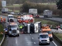 Rescuers work on the A2 motorway in Marly, northern France, after a truck was tipped over in the early morning from strong winds brought by storm Ciara on February 10, 2020. Hundreds of flights and train services were cancelled on February 10 as Storm Ciara sweeps over northwest Europe packing powerful winds, and leaving swatches of Europe without power after unleashing torrential rain and causing flash flooding. FRANCOIS LO PRESTI / AFP