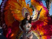 A participant in fancy dress takes part in the 136th Nice Carnival parade which celebrates this year the 'Fashion King' in Nice, southeastern France, on February 15, 2020. The carnival runs from February 15 to February 29, 2020. VALERY HACHE / AFP