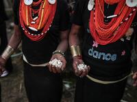 This photo taken on February 7, 2020 shows Naga tribeswomen holding rice at the end of an overnight ceremony to bless the harvest in Satpalaw Shaung village, Lahe township in Myanmar's Sagaing region. A haunting refrain pierces the night as the tribeswomen of the Gongwang Bonyo, among the most isolated people in Myanmar, dance around a campfire to bless the harvest ahead. Ye Aung THU / AFP