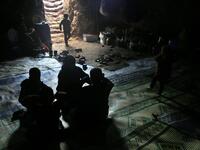Members of a family of internally displaced Syrians sit together in an underground shelter where several families from Aleppo and Idlib provinces are taking refuge, in the village of Taltunah about 15 kilometres northwest of Idlib in the northwestern Idlib province, on February 23, 2020. Aref TAMMAWI / AFP