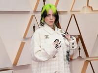 Billie Eilish in a white-on-white houndstooth set, with a jacket featuring the Chanel's interlocking "C" logo