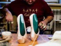 An employee of Grishko company produces pointe shoes in the company's Moscow workshop on February 25, 2020. Born in the chaos of the collapse of the Soviet Union, the Grishko family business has emerged among the top makers in the world of dance shoes, notably classic ballet pointe shoes, worn on the world's great stages. Dimitar DILKOFF / AFP