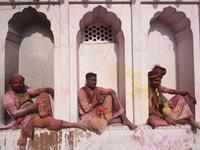 Hindu devotees sit in the columns of a temple as they take a break from participating in Holi celebrations, the spring festival of colours, during a traditional gathering at a temple in Nandgaon village in Uttar Pradesh state on March 5, 2020. Holi is observed in India at the end of the winter season on the last full moon of the lunar month. Money SHARMA / AFP