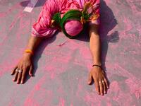 A Hindu devotee lies down as he enters the temple on the occasion of Holi, the spring festival of colours, during a traditional gathering at a temple in Nandgaon village in Uttar Pradesh state on March 5, 2020. Holi is observed in India at the end of the winter season on the last full moon of the lunar month. Money SHARMA / AFP