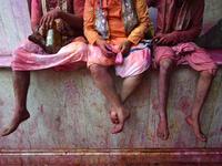 Hindu devotees sit in the column of a temple as they celebrate Holi, the spring festival of colours, during a traditional gathering at a temple in Nandgaon village in Uttar Pradesh state on March 5, 2020. Holi is observed in India at the end of the winter season on the last full moon of the lunar month. Money SHARMA / AFP