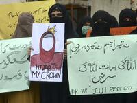 Burqa-clad female activists of Islamic political party Jamiat Ulema-e-Islam (JUI-F), carry placards during a rally to mark the International Women's Day in Peshawar on March 8, 2020. Thousands of people are expected to rally in cities across Pakistan on March 8 to mark International Women's Day in an ultra-conservative society where women are still put to death under ancient "honour" codes. Abdul MAJEED / AFP