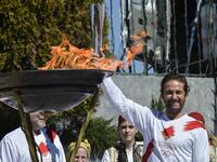 US actor Gerard Butler poses with the Olympic flame during the Olympic flame relay in Sparta on March 13, 2020 ahead of the Tokyo 2020 Olympic Games. Valerie Gache / AFP