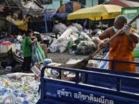 A Buddhist monk sorts salvaged plastic bottles to be recycled into monks’ robes and face masks, amid concerns over the spread of the COVID-19 coronavirus, at Wat Chak Daeng Buddhist temple in Samut Prakan on March 23, 2020. The plastic wastes are sent to a separate recycling facility processing it into thread materials and woven as special fabric for monks. Lillian SUWANRUMPHA / AFP