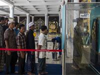 Indonesians walk through a disinfectant chamber before entering a mosque during Friday prayers in Surabaya, East Java on March 27, 2020, as a measure to stop the spread of the COVID-19 coronavirus. JUNI KRISWANTO / AFP