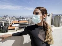 Sherazade Mami, a 28-year-old Tunisian professional dancer and performer at the Caracalla dance theatre and a teacher at the Caracalla dance school, practices while wearing a surgical mask on the roof of her apartment building in the suburb of Dekwaneh on the eastern outskirts of Lebanon's capital Beirut on April 4, 2020. Due to the confinement regulations imposed to combat the COVID-19 coronavirus pandemic, Mami opted to continue practicing on her rooftop to remain in shape. JOSEPH EID / AFP