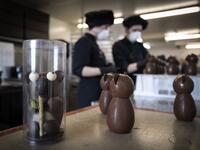 Employees work in the laboratory of the of the Criollo chocolate factory as they prepare chocolate for the Easter week, on April 06, 2020 in Saint-Pierre-De-Lages near Toulouse southern France, on the twenty-first day of a strict lockdown in France to stop the spread of COVID-19, caused by the novel coronavirus. Lionel BONAVENTURE / AFP