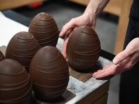 French chocolate maker Jeremy Thierry, adjusts a display chocolate Easter eggs in the workshop 'Atelier N° 5' in La Foret-Fouesnant, western France on April 7, 2020, ahead of the Christian Festival of Easter. Fred TANNEAU / AFP